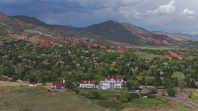 Ken Caryl Valley Ranch neighborhood The Manor House historic white building aerial drone Front Range Denver Colorado Rocky Mountains foothills cloudy summer morning clouds Red Rocks Park amp circle