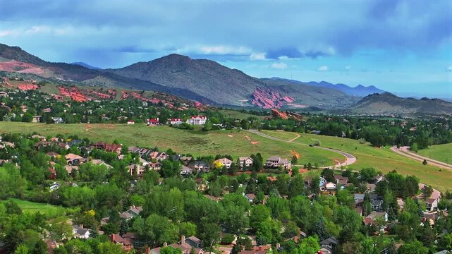 Ken Caryl Valley Ranch neighborhood The Manor House Front Range Denver Colorado aerial drone Rocky Mountains foothills sunny summer morning blue sky clouds Red Rocks Park and Amphitheater forward up