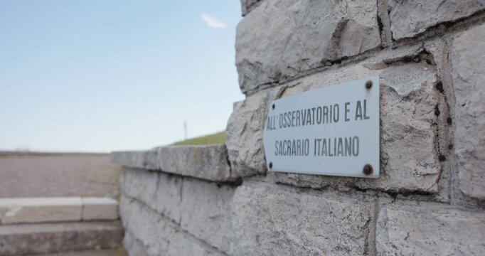 Sign Points Sacrario Italiano (Italian Military Shrine) At Sacrario Militare di Cima Grappa In Italy. Close-up Shot