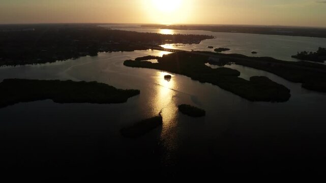 The sun sets over Braden River, casting a golden glow on the water and mangrove isles. Ideal for projects on nature, tranquility, or evening landscapes.