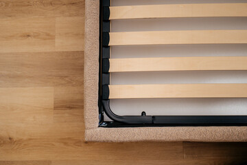 Obraz premium New wooden slats are placed on the bed base in a bedroom for support and comfort