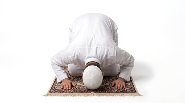Muslim man performing prayer on a rug