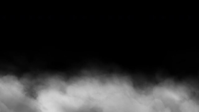 Volumetric smoke billowing across the ground against a transparent background. Seamless 4K video.