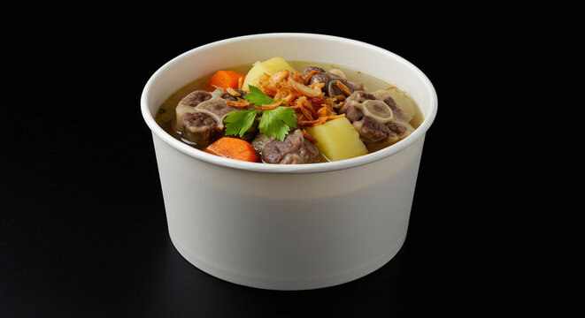 Indonesian Oxtail Soup in White Paper Takeaway Bowl on Black