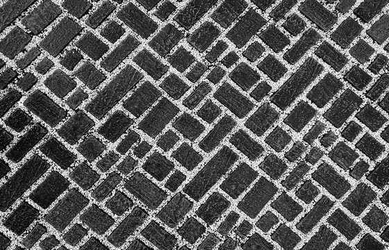 Black cobblestone paving blocks texture background with white pebbles grout lines for modern architecture mockup design