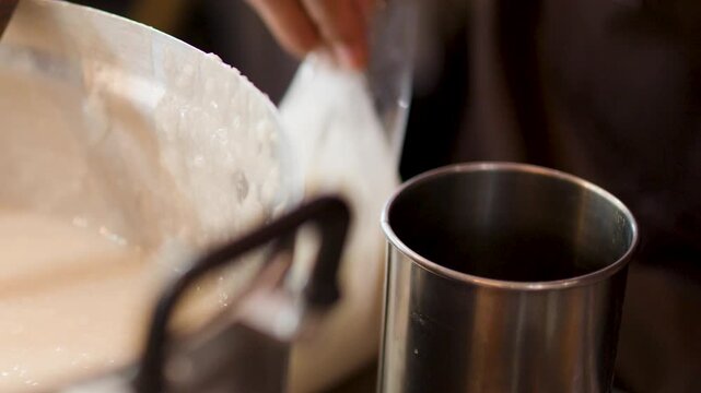 Close Up of Street Vendor Preparing Rice Porridge in Metal Pot