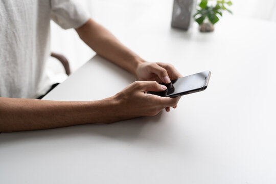 Man using smartphone close up representing social media addiction and excessive screen time