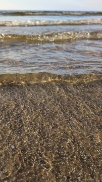 Soothing sea wave oncoming on a baltoc sandy beach.