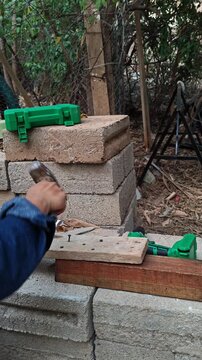 A self tapping screw breaking after being struck heavily by a sledgehammer