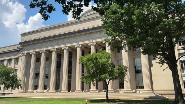 MIT&rsquo;s Building 10 Great Dome side of the main campus, with the colonnaded facade, carved &ldquo;Massachusetts Institute of Technology&rdquo; inscription, and the dome peeking over the roofline.