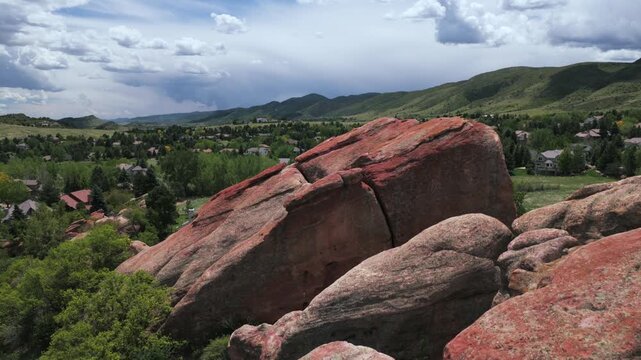 Red Rocks hiking Ken Caryl Valley Ranch neighborhood tennis court North Valley Meadow Ranch Front Range Denver Colorado aerial drone Rocky Mountains foothills cloudy summer morning forward upan
