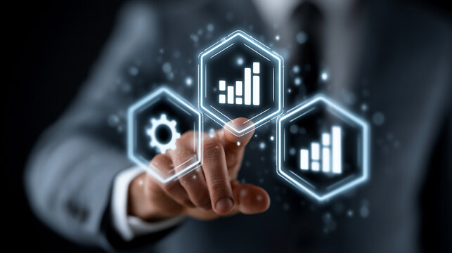 Businessman selects digital hexagonal modules featuring gear and bar chart icons to manage complex business logistics and data analytics for sustainable company growth in a virtual workspace setting.