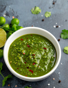 Aji Verde, spicy peruvian green sauce in bowl. Tasty aromatic dip or dressing. Cooking and culinary concept. Close-up.