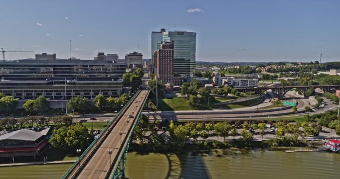 Knoxville Tennessee Aerial v18 tracking shot above the river capturing downtown cityscape and traffics motion on bridges at daytime - Shot with Inspire 2, X7 camera - August 2020
