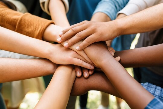 Diverse youth unite hands in a powerful outdoor gesture of global friendship