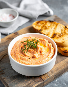 Smoked salmon dip in bowl and toasted bread. Tasty snack. Delicious food. Close-up.