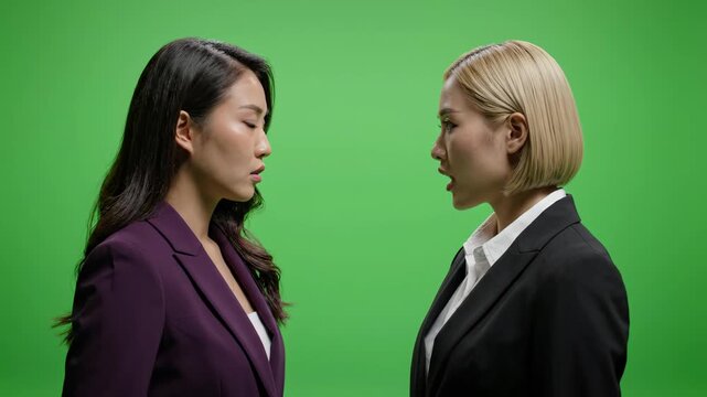 Two Businesswomen Arguing Face-to-Face on Green Screen Background
