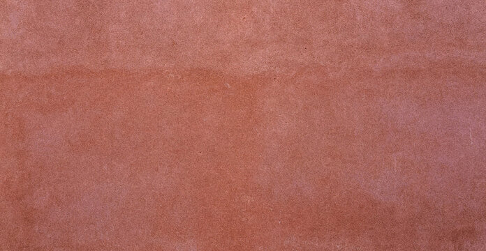 A textured background featuring a warm terracotta color with subtle variations in tone. Ideal for design projects, wallpapers, or fabric applications.