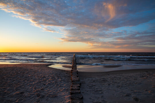 Dramatic sunset on the beach in Dziwnow, Poland