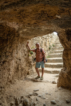 Male traveler visiting archaeological ruins of ancient Paphos in Cyprus. UNESCO World Heritage Site, Mediterranean history, cultural exploration and tourism concept.