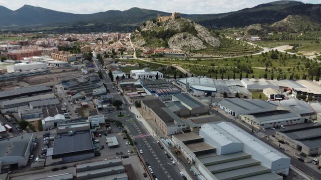 Industrial estate with the town and castle of Castalla in the background, Spain.