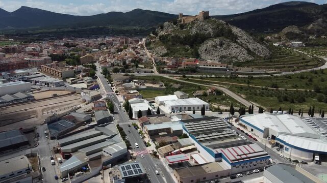 Flying over the industrial estate to approach the town of Castalla, Spain, with the Moorish castle in the background.