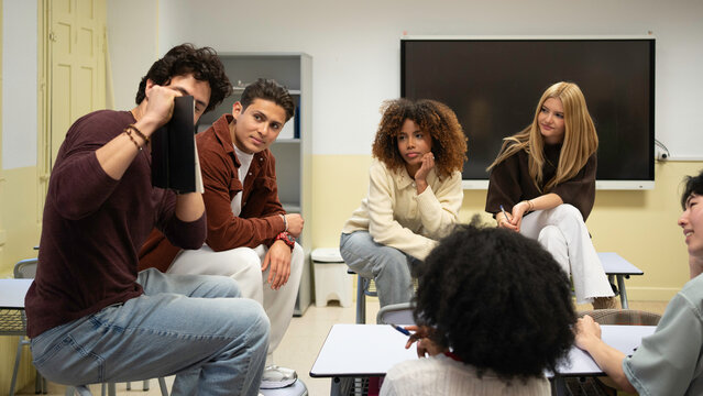 Diverse students engaging in a group discussion, sharing ideas and learning together in a classroom