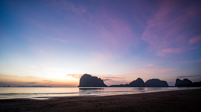 Beautiful twilight sky at a tropical beach, dramatic clouds drifting over the turquoise sea.