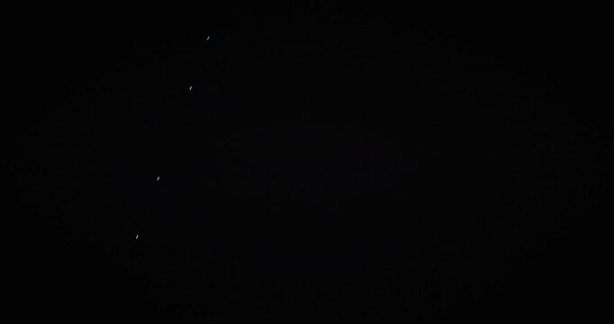 Satellite train light trails crossing dark night sky, time lapse long exposure