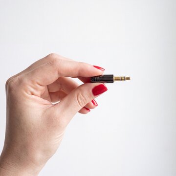 Hand holding audio jack connector, Close-up