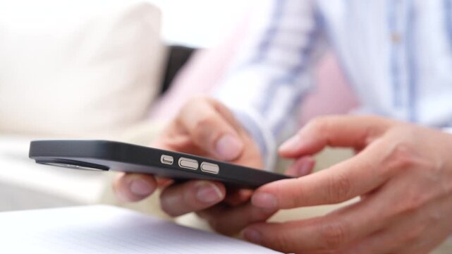 Close up hand using finger to sign a digital document on smartphone. Electronic signature, E-signature, online approval, Mobile business, secure authentication, Digital transformation.