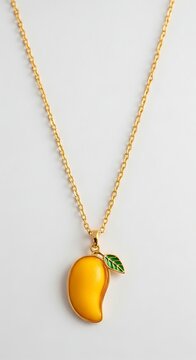 Gold Mango Pendant Necklace Displayed on Light Neutral Background