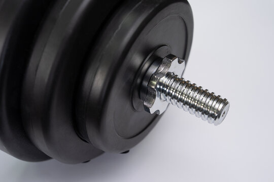 Close-up of barbell weight plates with star lock collar on white background