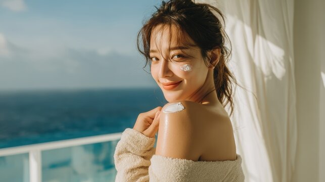 Young woman is using a white cream on her shoulder and her face,Facial care for female,moisturizing cream,healthy skin,Taking good care of her skin,Skin cream concept.