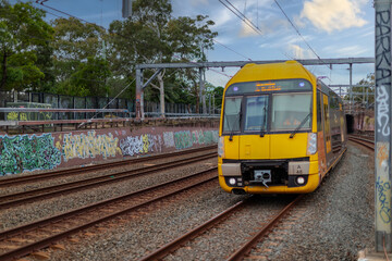 Fototapeta premium 7 July 2026 Passenger Train going through Lewisham Train Station at Sunset a suburban Sydney train Station in Sydney NSW Australia