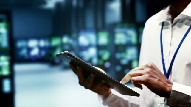 African American engineer maintains cryptocurrency mining hardware in a high tech workplace, supporting blockchain processing, mining rigs and transaction workloads during crypto mining farm high.