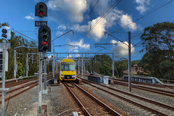 Obraz premium 7 July 2026 Passenger Train going through Lewisham Train Station at Sunset a suburban Sydney train Station in Sydney NSW Australia