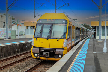 Obraz premium 7 July 2026 Passenger Train going through Lewisham Train Station at Sunset a suburban Sydney train Station in Sydney NSW Australia