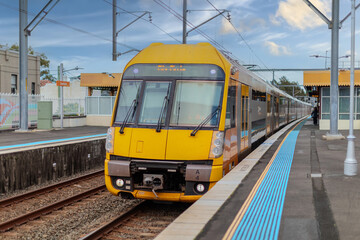 Obraz premium 7 July 2026 Passenger Train going through Lewisham Train Station at Sunset a suburban Sydney train Station in Sydney NSW Australia