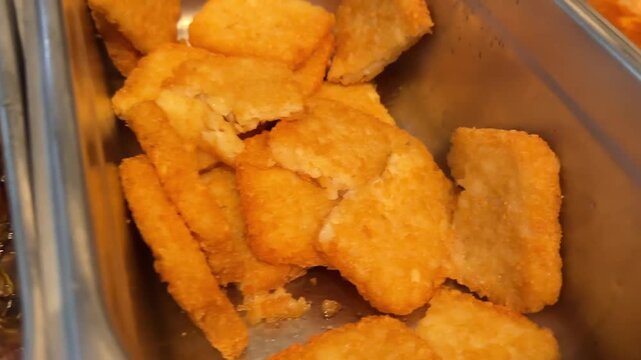 Close-up video of golden hash brown patties with crispy texture in a close up breakfast food scene.