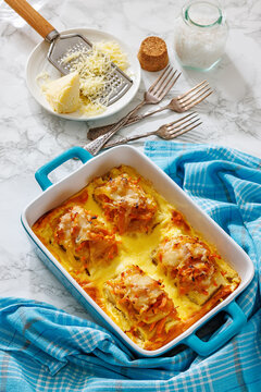 Cheesy Veggie Baked White Fish in blue baking dish