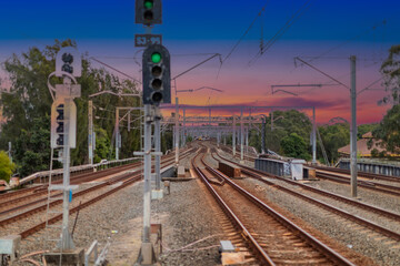 Fototapeta premium 7 July 2026 Passenger Train going through Lewisham Train Station at Sunset a suburban Sydney train Station in Sydney NSW Australia