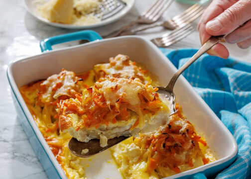 Cheesy Veggie Baked White Fish in blue baking dish