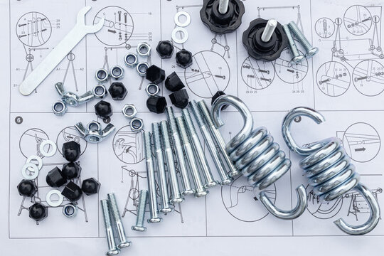 flat pack for garden furniture assembly, screw-nuts, screws, and parts on a paper furniture assembly instruction sheet
abstract technology background with various details