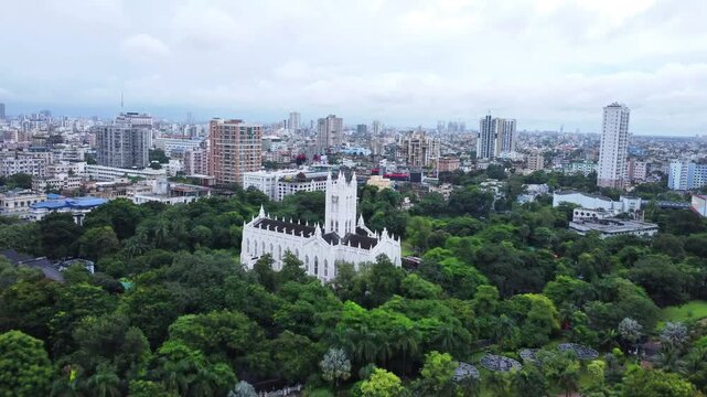 Aerial View of indian city with skylines and cityscape of Kolkata city. West Bengal during monsoon season. Drone view of Indian church St. Paul's Cathedral, Kolkata. India City During Monsoon. 