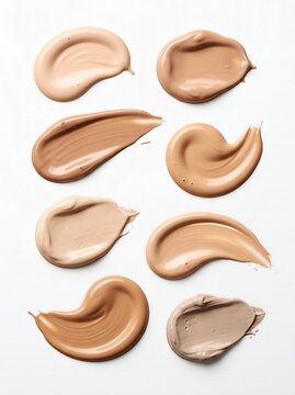 Set of liquid foundation cream swatches in different skin tone shades on white background