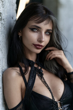 young goth woman portrait with pale gray eyes, petite alternative woman with striking gothic beauty, elegant gothic fashion model with dramatic features