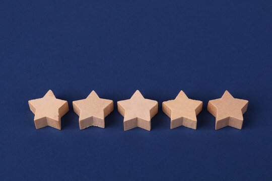 Five wooden stars on blue background