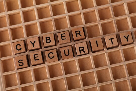 Close-up of wooden blocks with Cyber Security text on grid background