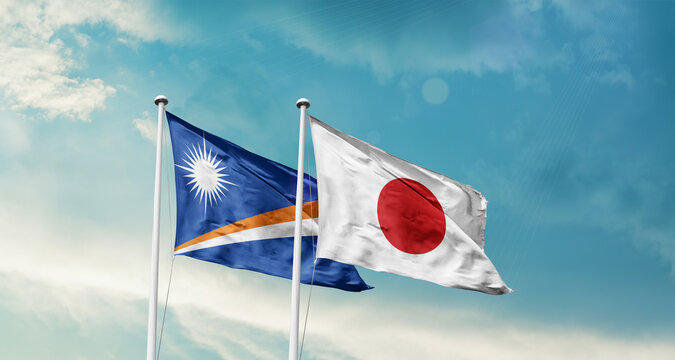 Marshall Islands and Japan friendship flags are waving in the sky. Two country flag for agreement or deal. Marshall Islands Japan national flag for commitment.